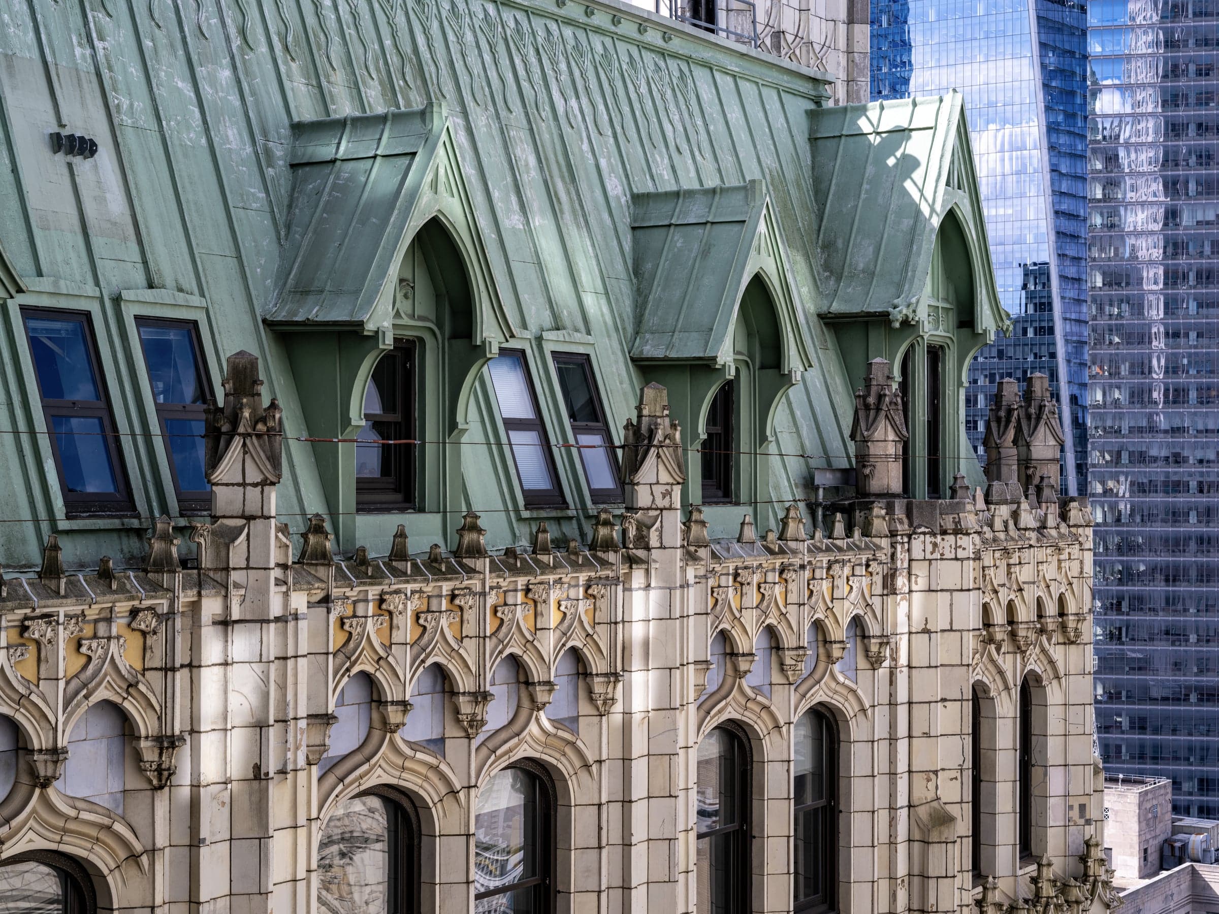 The Woolworth Building's patinated copper roof with Gothic dormers and carved pinnacles.