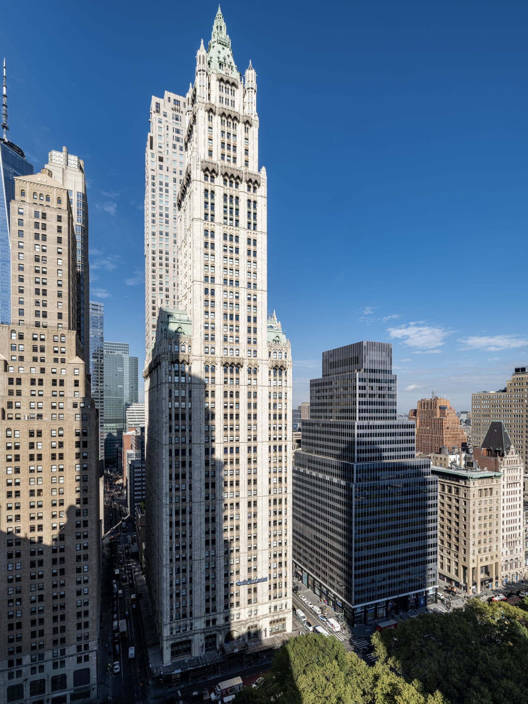 The full Woolworth Building seen from a neighboring rooftop, from base to crown.