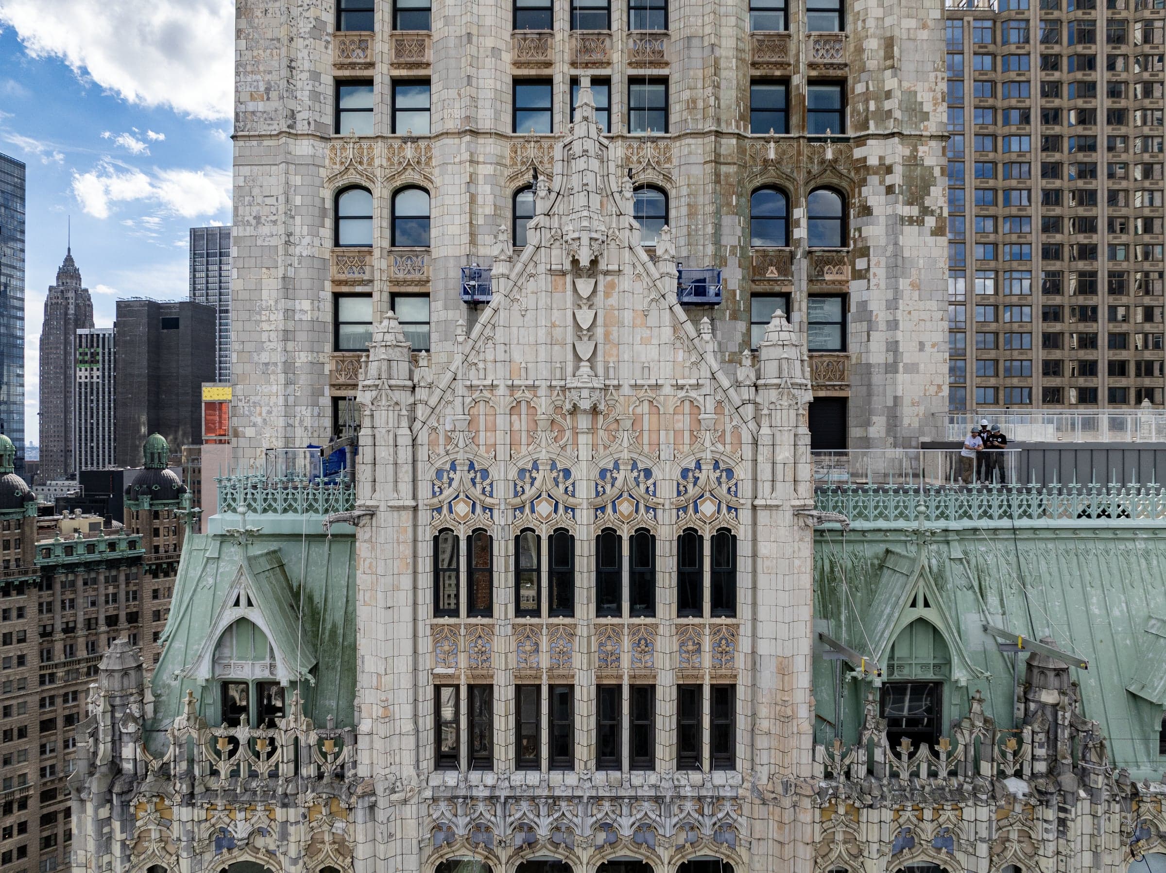 Aerial view of the Woolworth Building's upper facade with scaffold drops staged at the building.